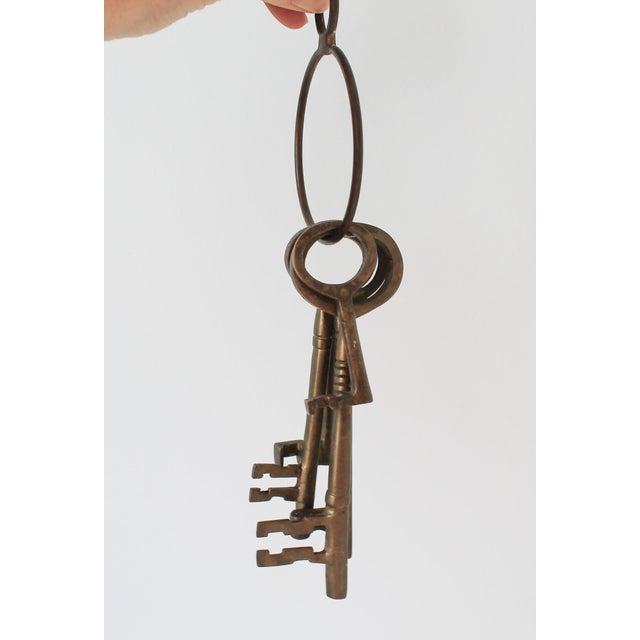 Set of five large vintage decorative brass skeleton keys on a brass ring with a loop on top for hanging. Made in India....