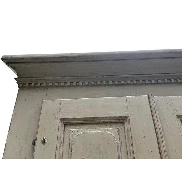 Perfect and already set up a media cabinet, this Swedish Gustavian cupboard in a lime-washed finish, 19th century, has two...