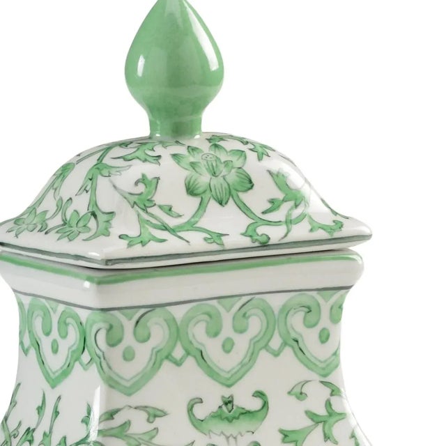 Glamorous in green, this covered urn has graceful curves and a removable top. Crafted of porcelain, this decorative accent...