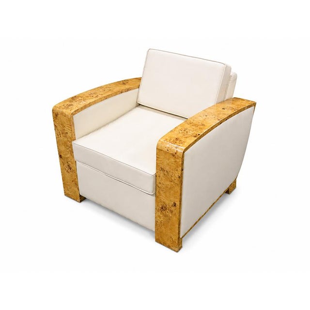 An elegant pair of armchairs in authentic Art Deco style, featuring a frame with enveloping, geometric lines, embellished...