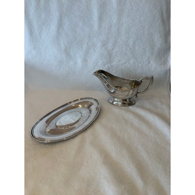 Simple lines and elegant design add to this Sterling Silver Fisher gravy boat's appeal with matching underplate.