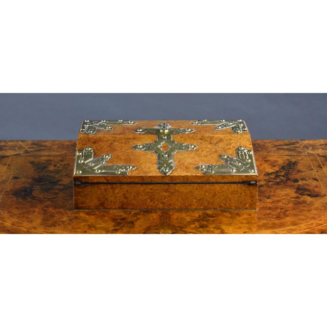For sale is a good quality Victorian brass strapwork mounted amboyna writing slope, with a fall front and hinged top...