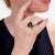 A fine vintage silver, onyx, and diamond ring. In sterling silver. With a bezel-set onyx cabochon head mounted with a...