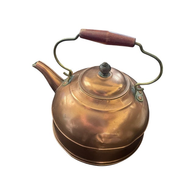 Copper tea kettle from mid-20th century made in Rome, NY by Revere Ware. Brass and wooden accents on handle and lid....