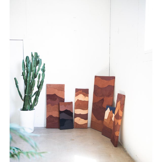 This painting is 24 x 12 inches. The work is made of layered leather on canvas. It includes hanging hardware and a wire...