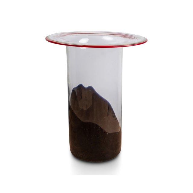 A vase with multiple openings and slits of varying sizes, nicknamed a "polyvase," its organic and dynamic silhouette is...