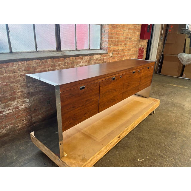 Attributed to Roger Sprunger for Dunbar rosewood and chrome credenza featuring richly grained Brazilian rosewood and...