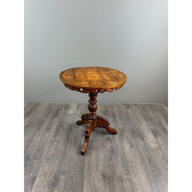 Inlaid Wood Side Table Charming inlaid wood side table, resting on a richly carved central base with three cabriole legs....