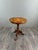 Inlaid Wood Side Table Charming inlaid wood side table, resting on a richly carved central base with three cabriole legs....