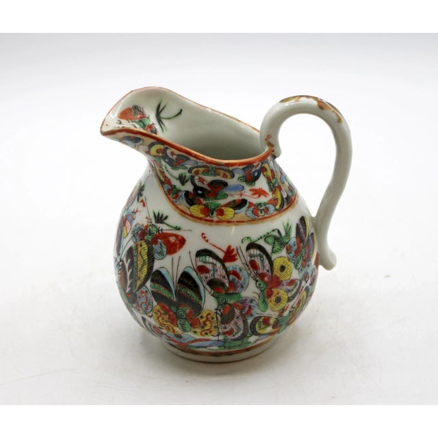 Circa 1880 Chinese export porcelain thousand butterfly creamer. Scroll handle with gilding; finely enamelled decoration...