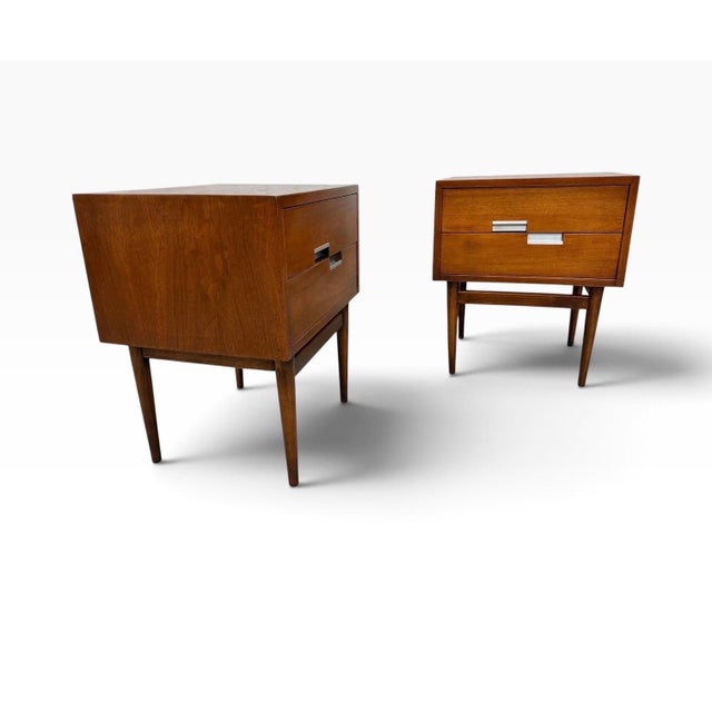 This striking pair of Mid-Century Modern American of Martinsville “Accord” walnut nightstands dates to the 1960s and...