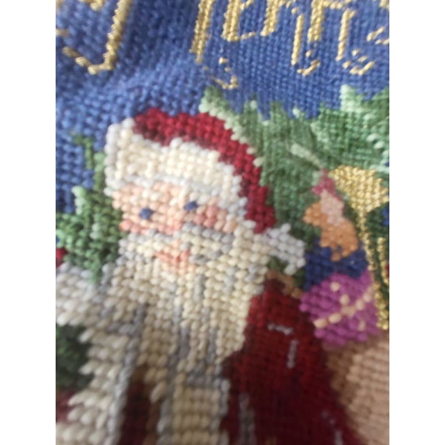 Vintage wool needlepoint Christmas stocking. Features an Old World Santa carrying a Christmas Tree.