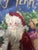 Vintage wool needlepoint Christmas stocking. Features an Old World Santa carrying a Christmas Tree.