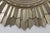 This is a dramatic contemporary sunburst mirror featuring a bold circular frame with radiating hand-carved rays finished...