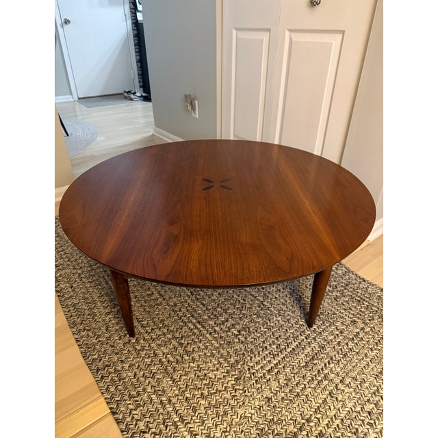 This is a beautiful wood walnut coffee table, from the Bassett Artisan Collection. It has a four petal floral inlay in the...