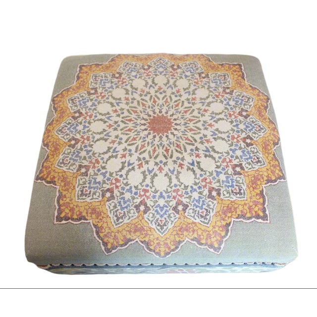 This ottoman has a colorful mandala pattern fabric with a complementary floral motif encircling the lower portion. Its...