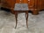 A French Louis XV style walnut side table from the 19th century, with grey marble top and bronze feet. Created in France...