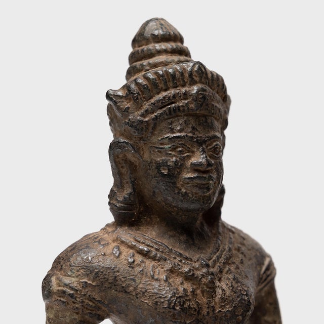 Sculpted in the manner of Khmer statuary, this cast bronze devotional figure depicts a standing Buddhist deity, most...