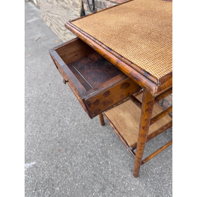 This is a beautiful 20th century English bamboo side table with drawer! Tables like these make excellent accent pieces...