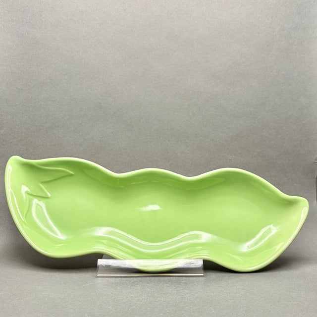 This charming mid-century modern serving dish is masterfully crafted in the shape of a large green bean, featuring a...