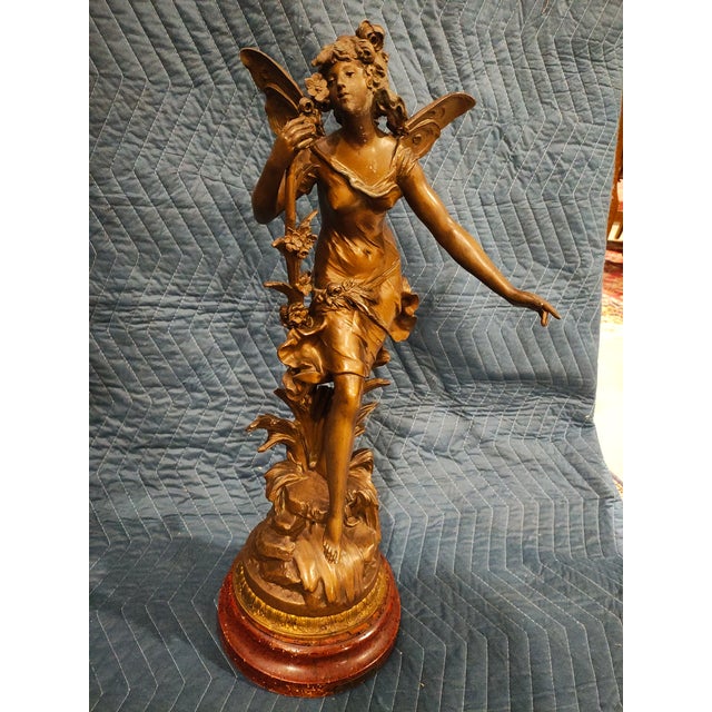 Circa 1890. Elegant French Belle Époque patinated spelter sculpture depicting a winged allegorical female figure in...