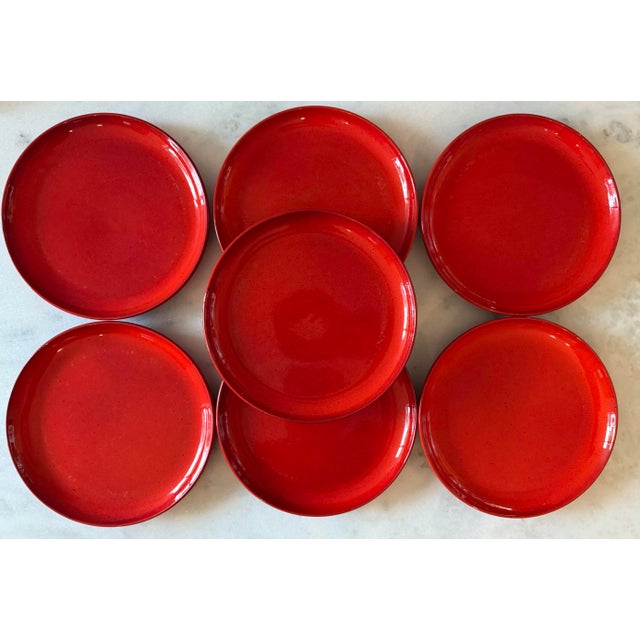 Set of 7 vintage mid century Gerz Germany pottery dinner plates. Striking bright orangish red color with brown flecks and...