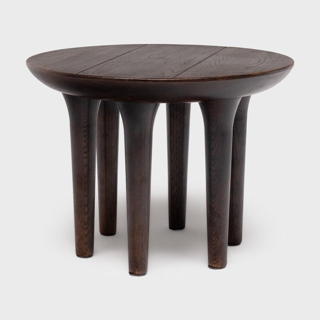 This modern side table has a minimalist form with clean lines and timeless materials. Crafted from reclaimed elm with a...