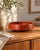 Sculptural vintage wooden bowl dating from approximately the 1960s. the bowl has a low, broad profile with a gently...