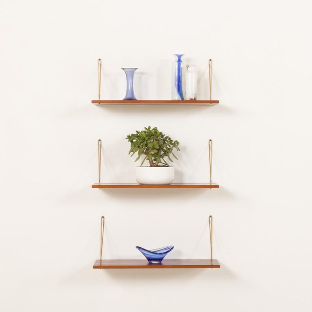 This set of three Danish mid-century floating shelves, designed in the 1960s, embodies timeless elegance. Crafted of solid...
