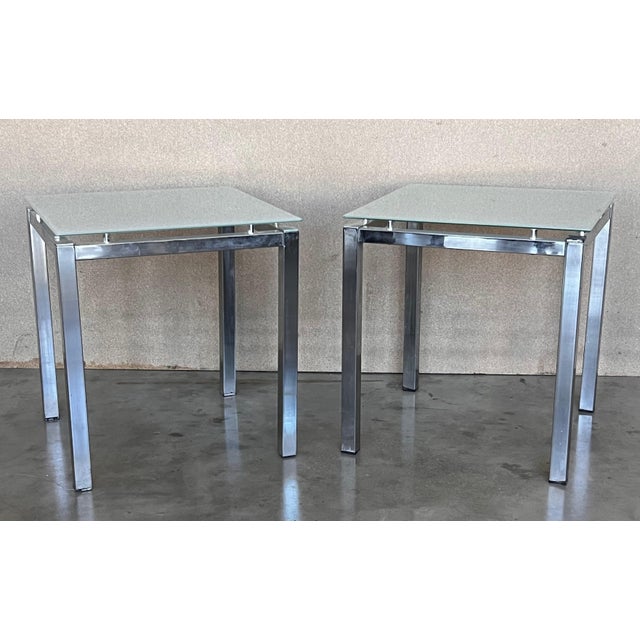 Introduce a dash of the 1970s to your living space with our pair of Postmodern tubular chrome and glass end tables....