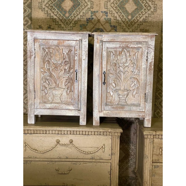 Pleasing and soft colors on this pair of painted, carved and distressed cabinets with shelf. Nice smaller size for those...