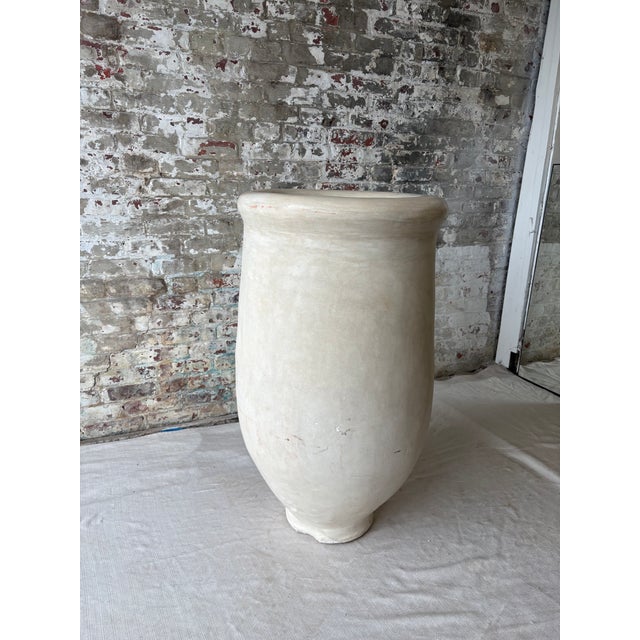 A beautifully oversized sculptural vessel featuring a softly organic silhouette, substantial scale, and warm stone-toned...