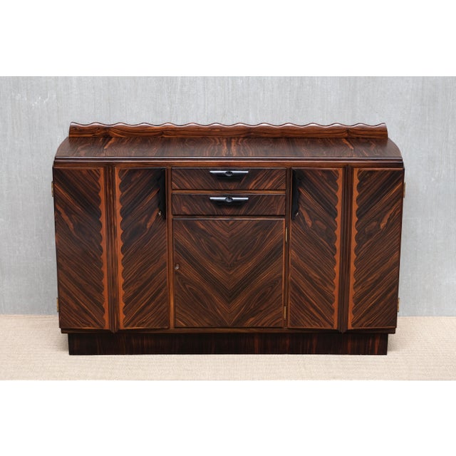 This important Amsterdam School cabinet was produced in the Netherlands in the late 1920s and is attributed to Napoleon Le...