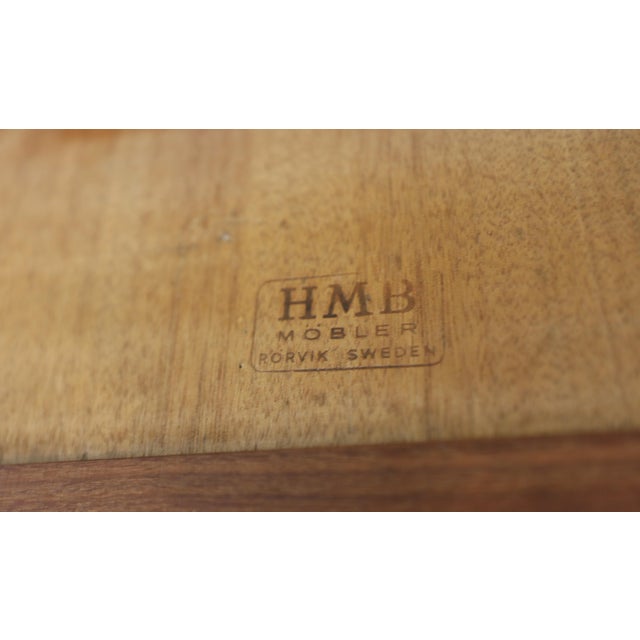 An elegant and well-built coffee table from HMB Rörvik, where the golden teak meets the darker walnut in an unusually...