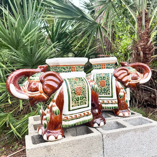 Charming pair of Boho Chic ceramic elephant planters featuring richly glazed surfaces with decorative green and terracotta...