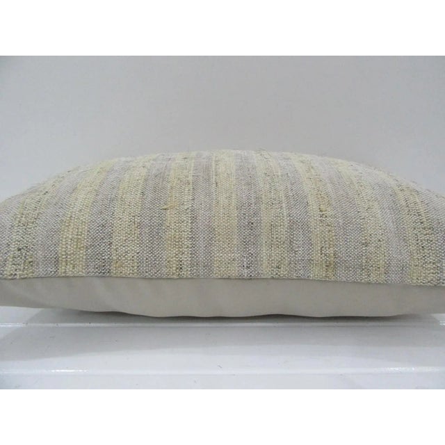 This is a pillow cover made from a vintage kilim rug. The piece was properly washed and ready to use. Pillow inserts not...