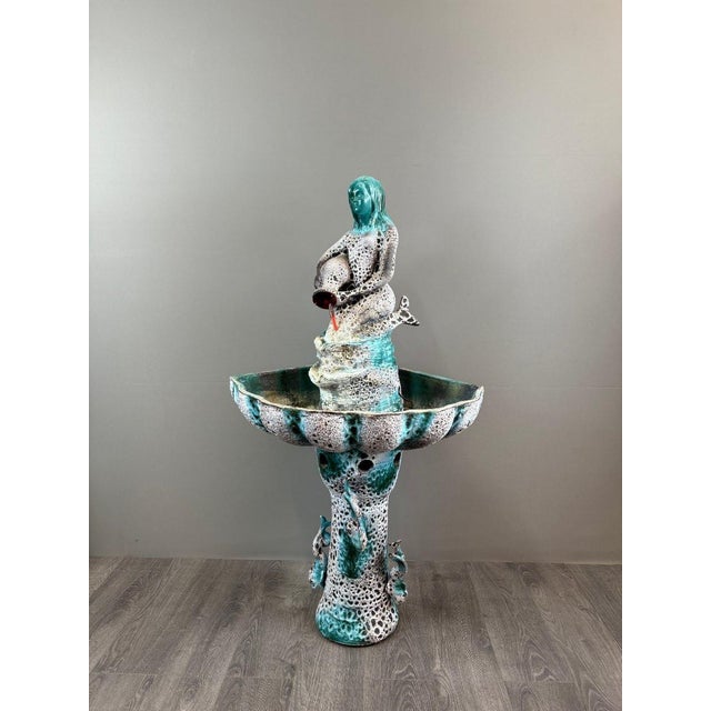 An imposing polychrome glazed ceramic fountain from Vallauris, a renowned center of 20th-century French ceramic art. It...