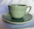 Mid-century, Chinese Longquan cup and saucer with a koi fish design, rich celadon glaze and crazing details. Cup measures...