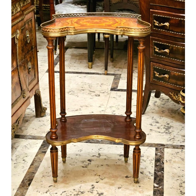 Add European elegance to your interior with this distinctive French-style side table, featuring an unusual sculptural...