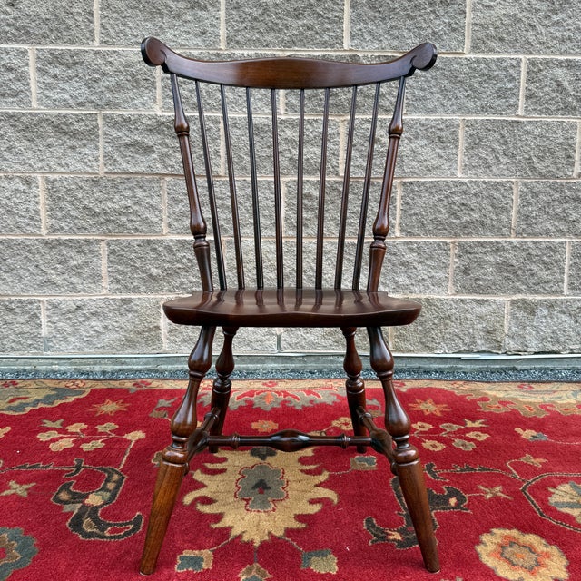 A vintage Nichols & Stone American Traditional solid cherry comb back Windsor dining chair or desk chair in dark brown...