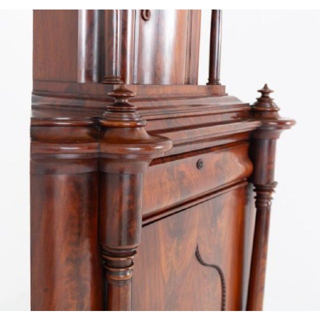 A wonderful Biedermeier corner cabinet crafted from beautifully figured flame mahogany Circa 1860 The lower section...