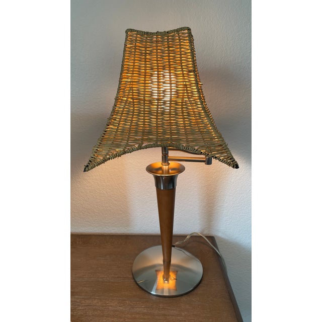 A stunning mid-century modern table lamp by Emess Lighting Inc. This piece features a striking combination of mixed metal...