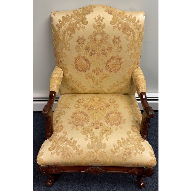 Elegant vintage armchair by Statesville Chair Company, featuring a beautifully carved hardwood frame with a rich, warm...