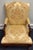 Elegant vintage armchair by Statesville Chair Company, featuring a beautifully carved hardwood frame with a rich, warm...