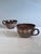 Handcrafted ceramic mugs from the Serocka workshop, decorated with delicate light lines and dots on a dark brown body. The...