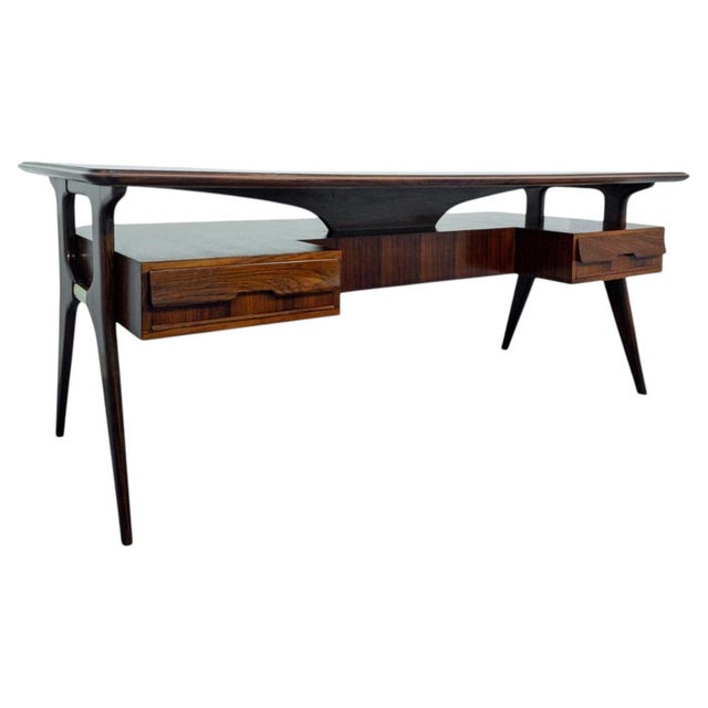 Stunning desk designed by Vitoro Dassi in the 1950s, featuring a black glass top beneath which is a wooden band shaped...