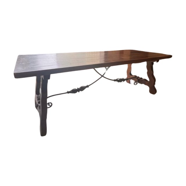 Antique Spanish dining table with hand forged wrought-iron stretcher from the late 19th century. This table features a...