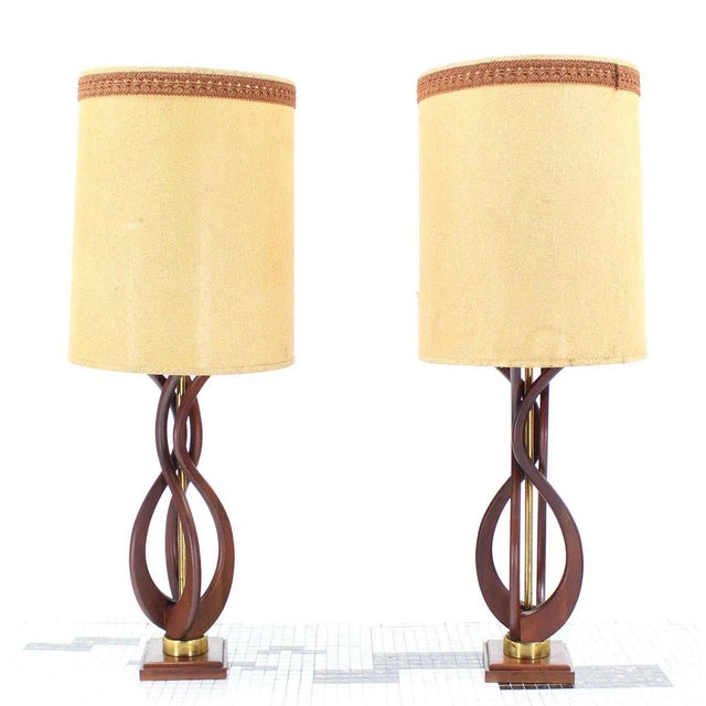 Pair of very nice looking, quality oiled walnut finish table lamps. The shades are as is and the bases are in excellent...