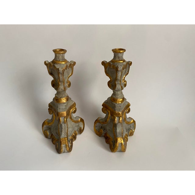 This elegant pair of Italian-style candlesticks features sculptural gray bodies highlighted with hand-applied gold gilt...