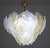 A stunning Murano glass chandelier featuring dozens of alternating leaves in clear and orange glass. The chandelier...